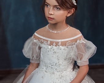 A chic dress for a flower girl made of glitter tulle. Dress with a lace bodice made of expensive guipurewith sequins and beads