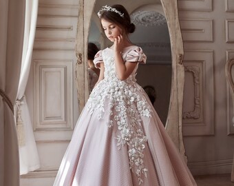 White dress in 3D flowers with beads for communion. Satin dress is with delicate polka-dot tulle. A dress with short beaded lantern sleeves.