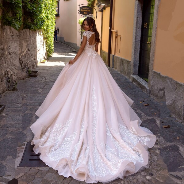 Fantastic wedding dress with gorgeous lace Macrame on the bodice and train. On the back there is a round openwork neckline | Collection 2020