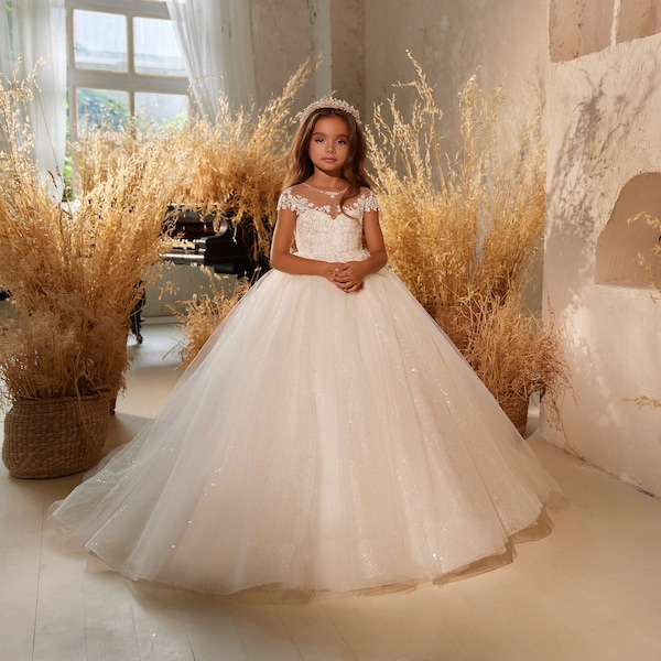 Designer communion dress with a lace bodice. Flower girl shining dress. Gorgeous ball gown with flared skirt, lace bodice and short sleeves