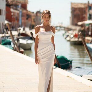 Wedding dress in a minimalist style. Satin dress with bare shoulders. Wedding satin dress with boat sleeves. Straight silhouette satin gown image 2