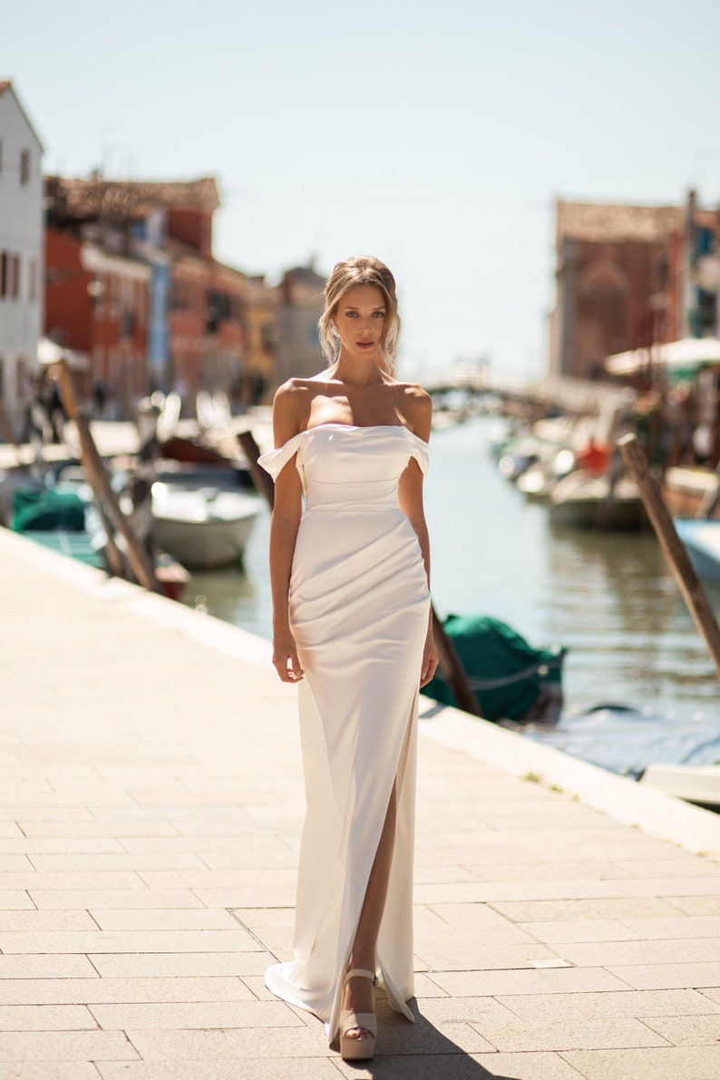 Wedding dress in a minimalist style. Satin dress with bare shoulders. Wedding satin dress with boat sleeves. Straight silhouette satin gown image 2