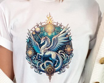 May include: White t-shirt featuring a detailed illustration of a winged unicorn within a circular, ornate design. The artwork incorporates shades of blue, gold, and teal, with celestial elements. The shirt is made of a soft material.