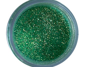 May include: A small jar filled with green glitter. The glitter has a slight iridescent sheen.