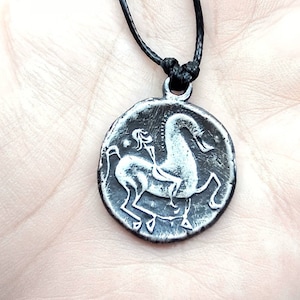 Ancient Dacian coin replica, silver pendant, tetradrachm second century BC, museum shop item, rider pagan Barbaricum, Dacia history