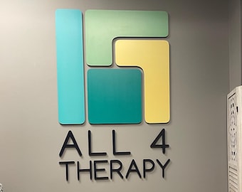 May include: A business sign with a colorful geometric design in shades of teal, green, and yellow. The text "ALL 4 THERAPY" is written in black below the design.