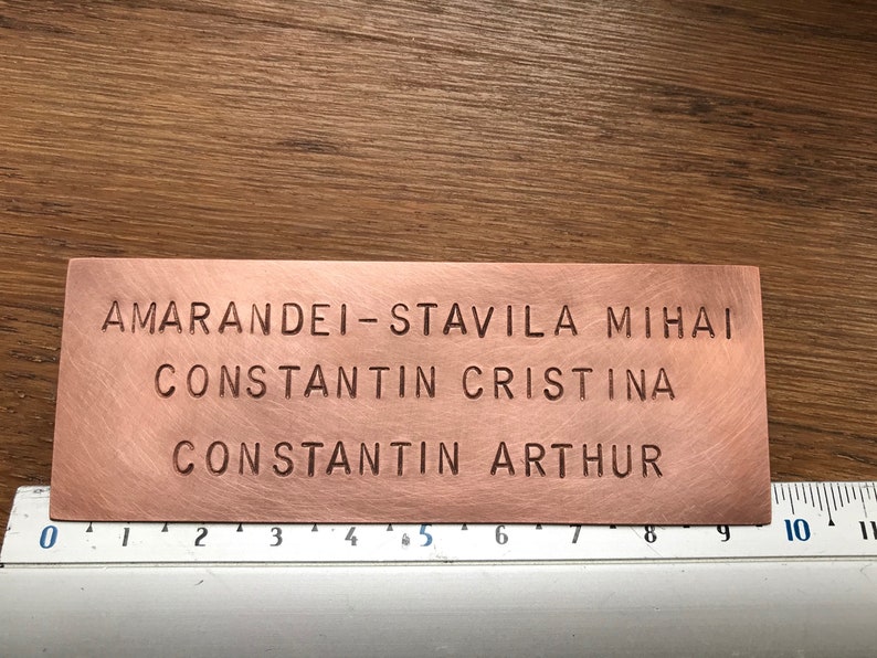 May include: A copper plaque with the names "AMARANDEI-STAVILA MIHAI CONSTANTIN CRISTINA CONSTANTIN ARTHUR" engraved in a serif font.