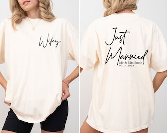 May include: A white t-shirt with the word "Wifey" printed on the front and "Just Married" with the date "07.14.2024" and "Mr & Mrs Smith" printed on the back.