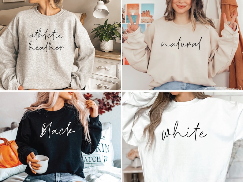 May include: Four different colored sweatshirts with the words "athletic heather", "natural", "black", and "white" written in cursive on them.