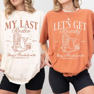 May include: Two white t-shirts with brown text and graphics. The left shirt says "My Last Rodeo" with a boot and a drink. The right shirt says "Let's Get Rowdy" with a boot and a drink. Both shirts say "Amy's Bachelorette Nashville, TN" and "Est. 2024".
