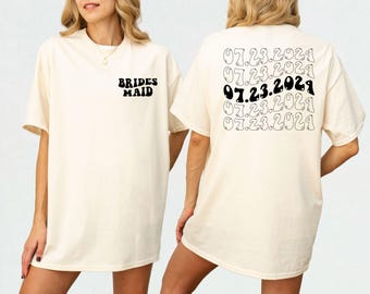May include: Two white t-shirts, one with the text "BRIDES MAID" and the other with the text "07.23.2021" repeated five times.