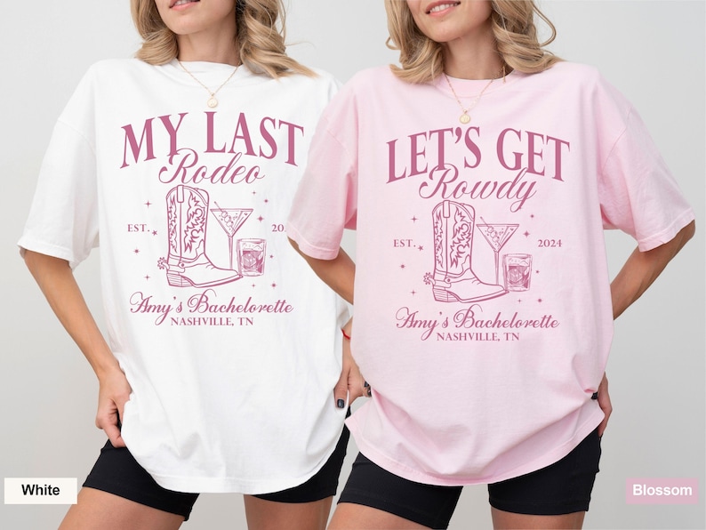 May include: Two white t-shirts with pink text and graphics. The left shirt says "My Last Rodeo" with a boot and a cocktail glass. The right shirt says "Let's Get Rowdy" with a boot and a cocktail glass. Both shirts say "Amy's Bachelorette Nashville, TN".