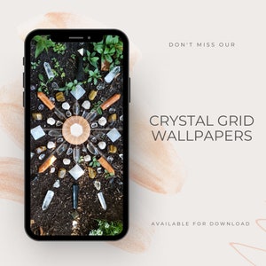 May include: A smartphone displaying a crystal grid wallpaper. The grid is made of various crystals, including clear quartz, tiger's eye, and rose quartz. The crystals are arranged in a circular pattern on a bed of dirt. The wallpaper is available for download.