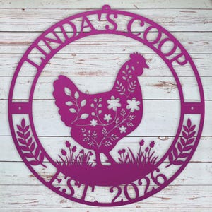 Decorative purple metal sign with a chicken design and 'Linda's Coop' text on a wooden background