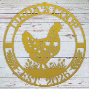 Decorative metal sign with chicken silhouette and text on a wooden background