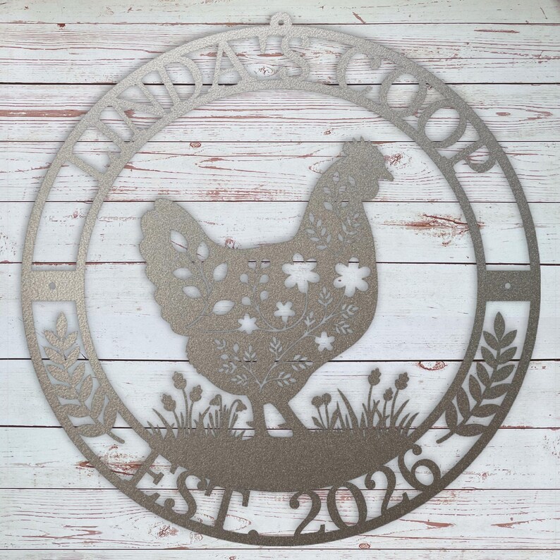 Decorative metal sign with a rooster silhouette and text on a wooden background