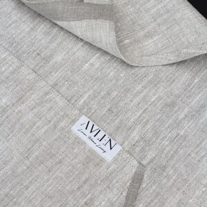 May include: A close-up of a light grey linen fabric with a white label that reads "AVLEN Linen Home Living".