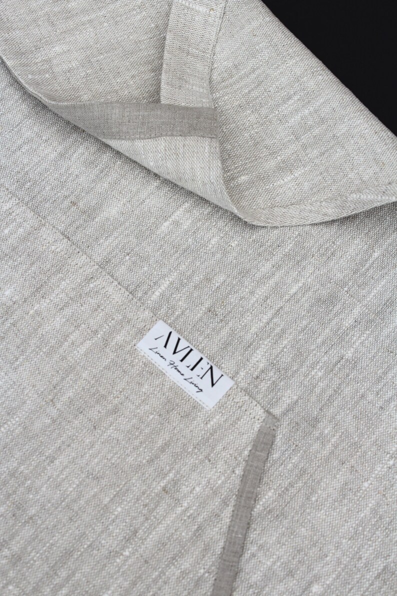 May include: A close-up of a light grey linen fabric with a white label that reads "AVLEN Linen Home Living".