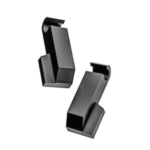 Puede incluir: Dos esculturas negras geométricas abstractas sobre un fondo blanco. Cada escultura tiene una base rectangular con una parte superior curva y un bloque más pequeño en ángulo adjunto. Las formas son sólidas y tridimensionales.