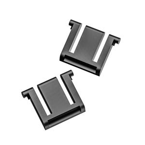 May include: Two black metal clips with a rectangular design and a U-shaped opening. The clips are positioned at a slight angle against a white background, showcasing their shape and structure.