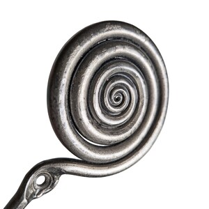 May include: A dark silver-toned metal wall hook featuring a prominent circular spiral design at the top. The hook has a textured, weathered finish and includes a single circular mounting hole at the base of the spiral for attachment to a surface.
