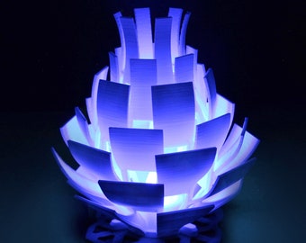 May include: A white, 3D printed lamp shaped like a pineapple with a blue glow emanating from the inside.