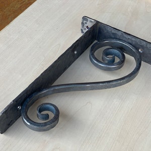Hand forged metal shelf bracket. Shelves storage.