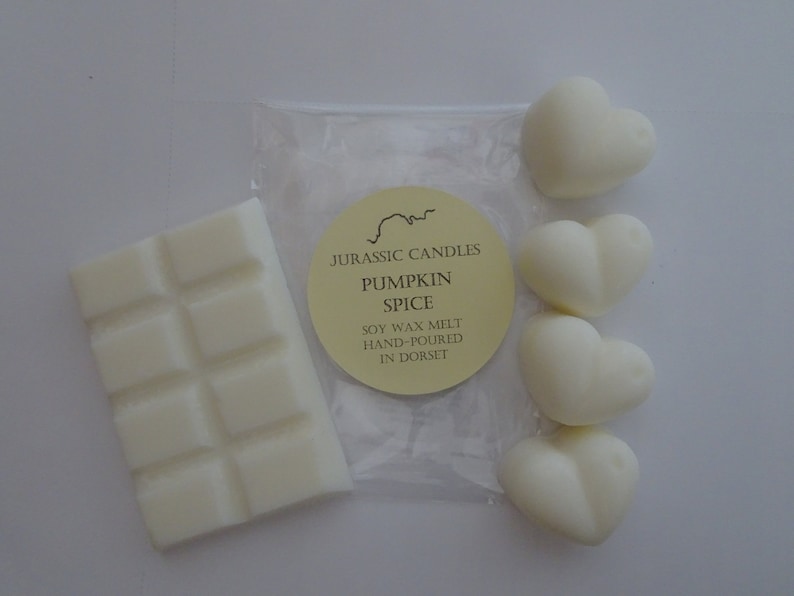 May include: A set of wax melts in a heart shape, a wax bar, and a label that reads "Jurassic Candles Pumpkin Spice Soy Wax Melt Hand-Poured in Dorset."