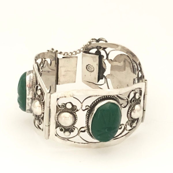 Plateria FarFan 925 Sterling Silver and Carved Jade Mayan Faces Cuff Wide Linked Bracelet with Cut Away and Curled Silver circa 1940s