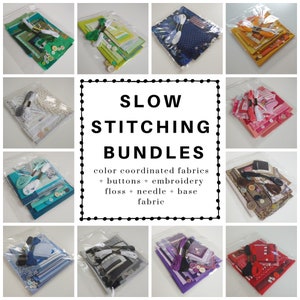 May include: A collection of twelve craft kits labeled SLOW STITCHING BUNDLES, each containing color-coordinated fabric pieces, assorted buttons, embroidery floss, and a needle, all packaged in clear plastic bags for organized textile projects.