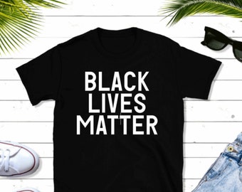 May include: Black t-shirt with the text "Black Lives Matter" printed in white.