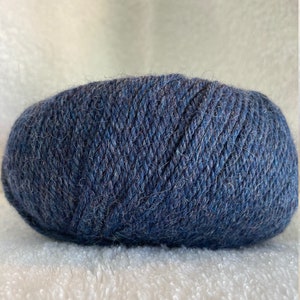 May include: A ball of dark blue yarn with a fuzzy texture.