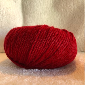 May include: A ball of bright red yarn.