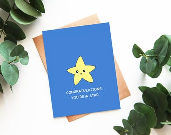 May include: A blue card with a yellow cartoon star with a smiling face. The card says "Congratulations! You're a star."