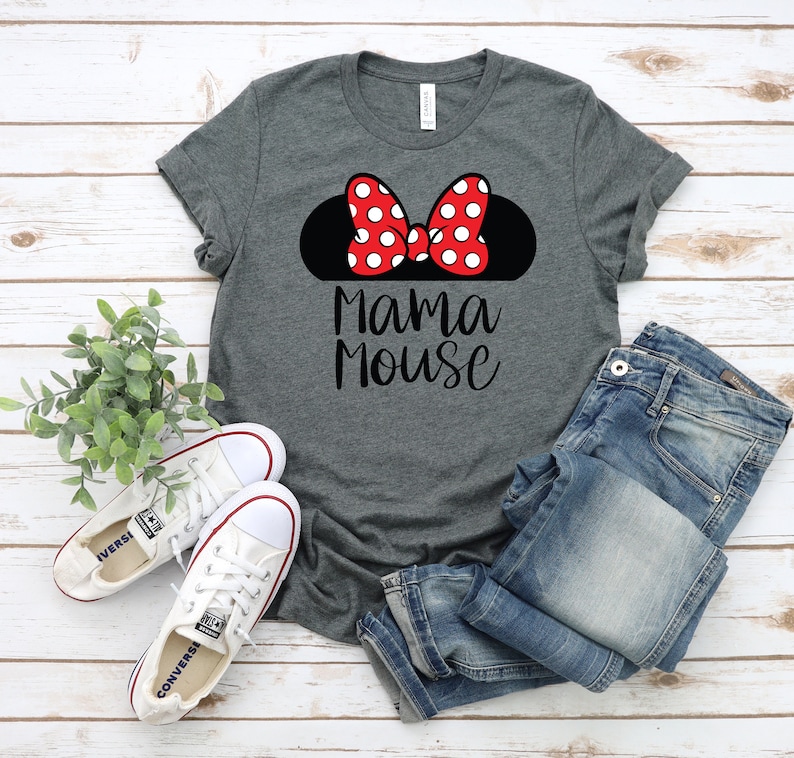May include: A grey t-shirt with a black silhouette of Mickey Mouse ears with a red bow with white polka dots. The text "Mama Mouse" is printed in black below the ears.