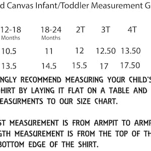 May include: A size chart for infant and toddler clothing, showing measurements in inches for body width (chest) and length. The chart includes sizes from 12-18 months to 5T.  The text reads: "We strongly recommend measuring your child's best fitting shirt by laying it flat on a table and comparing those measurements to our size chart. The chest measurement is from armpit to armpit. The length measurement is from the top of the collar to the bottom edge of the shirt."