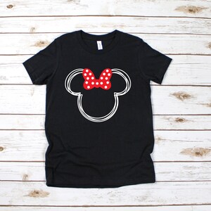 May include: Black t-shirt with a white outline of Mickey Mouse's head and a red bow with white polka dots.