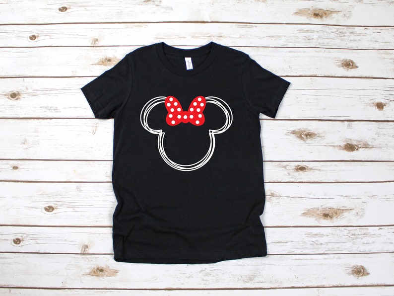 May include: Black t-shirt with a white outline of Mickey Mouse's head and a red bow with white polka dots.