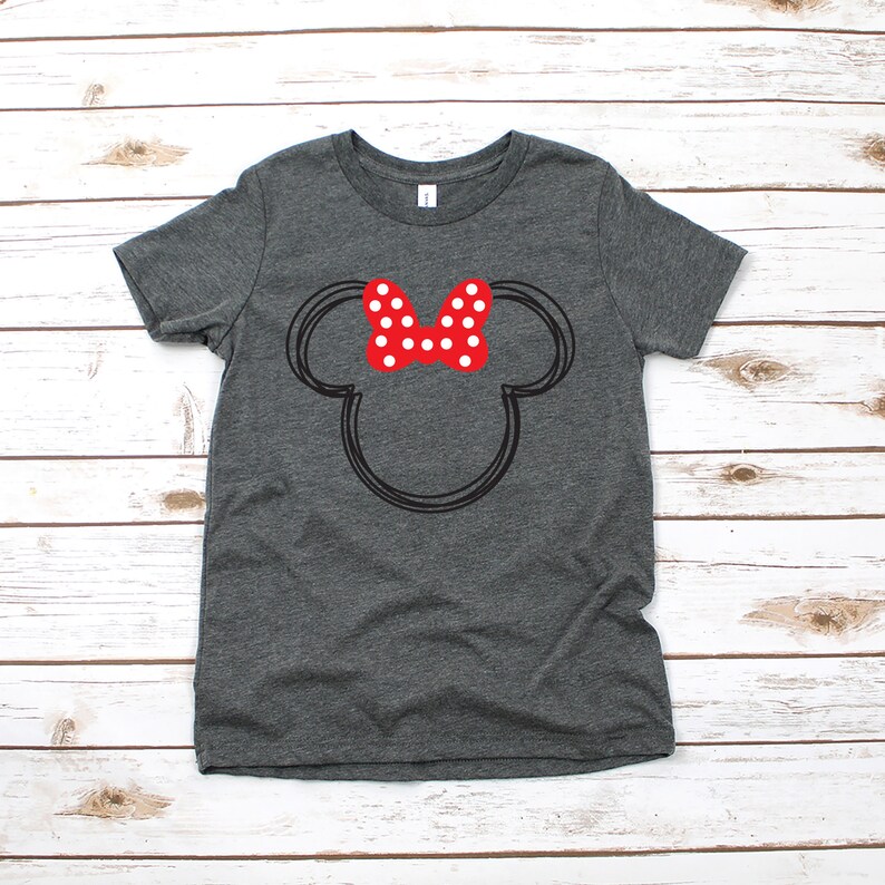 May include: A dark gray t-shirt with a black outline of Mickey Mouse's head and a red bow with white polka dots.