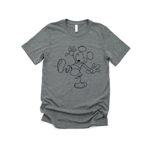 Puede incluir: Una camiseta gris jaspeada con un dibujo de l&iacute;nea negra de Mickey Mouse. El dibujo est&aacute; estilizado para parecer una sola l&iacute;nea.