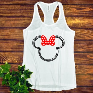 May include: White tank top with a black and white outline of Mickey Mouse's head with a red bow with white polka dots.