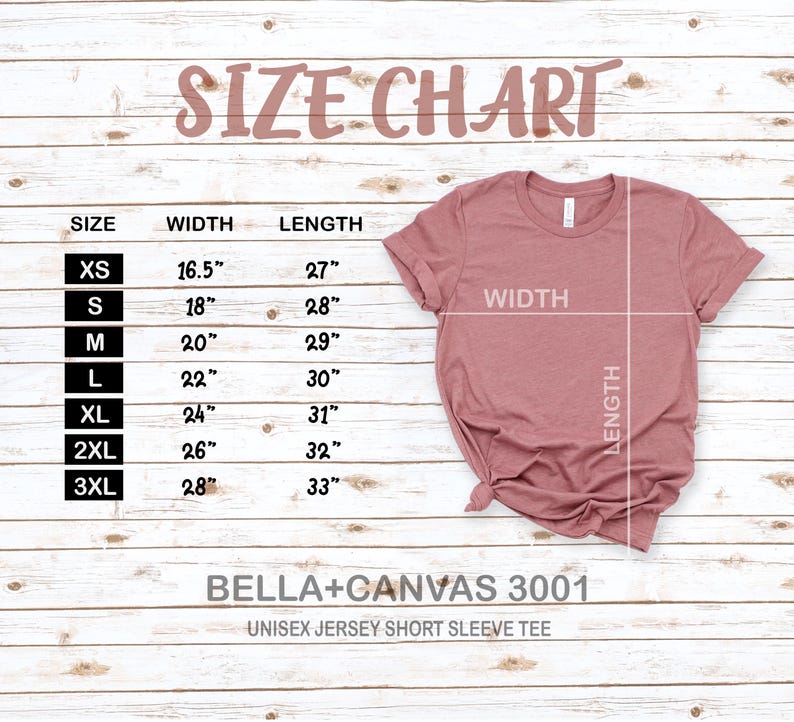 May include: A size chart for a unisex jersey short sleeve tee, with measurements in inches. The chart lists sizes XS to 3XL, with corresponding width and length measurements. A dusty rose colored t-shirt is displayed on a wooden background.