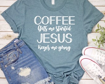 May include: Teal blue t-shirt with white text that reads "COFFEE Gets me started JESUS keeps me going". The shirt is paired with denim shorts and white sneakers.