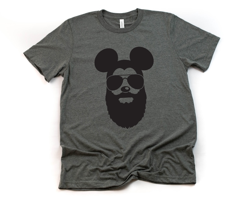 May include: A dark grey t-shirt featuring a black silhouette of Mickey Mouse wearing sunglasses and a beard.