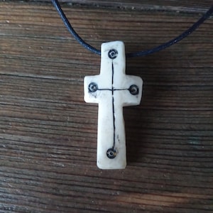 Christian cross made of bone with historical pattern