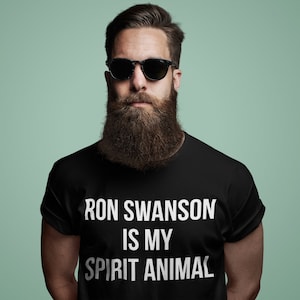 May include: A man wearing black sunglasses and a black t-shirt with the text "Ron Swanson is my spirit animal" printed in white.