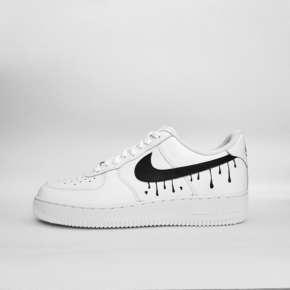 black nike sneakers with white swoosh