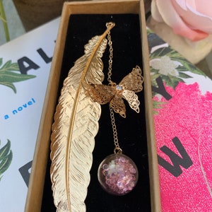 Gold metal feather bookmark with butterfly and flower pendant, teacher gift, bookish gift, book art, feather bookmark, book lover gift