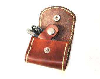 Mini leather pouch with cord tie.  For charger cord, earphones