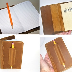 May include: A brown leather notebook cover with a pencil holder and the text "FIELD BOOK" on the inside cover.